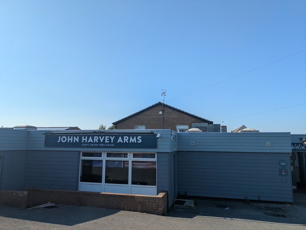 a bungalow looking pub exterior around a brick house with an old school tv aerial poking out