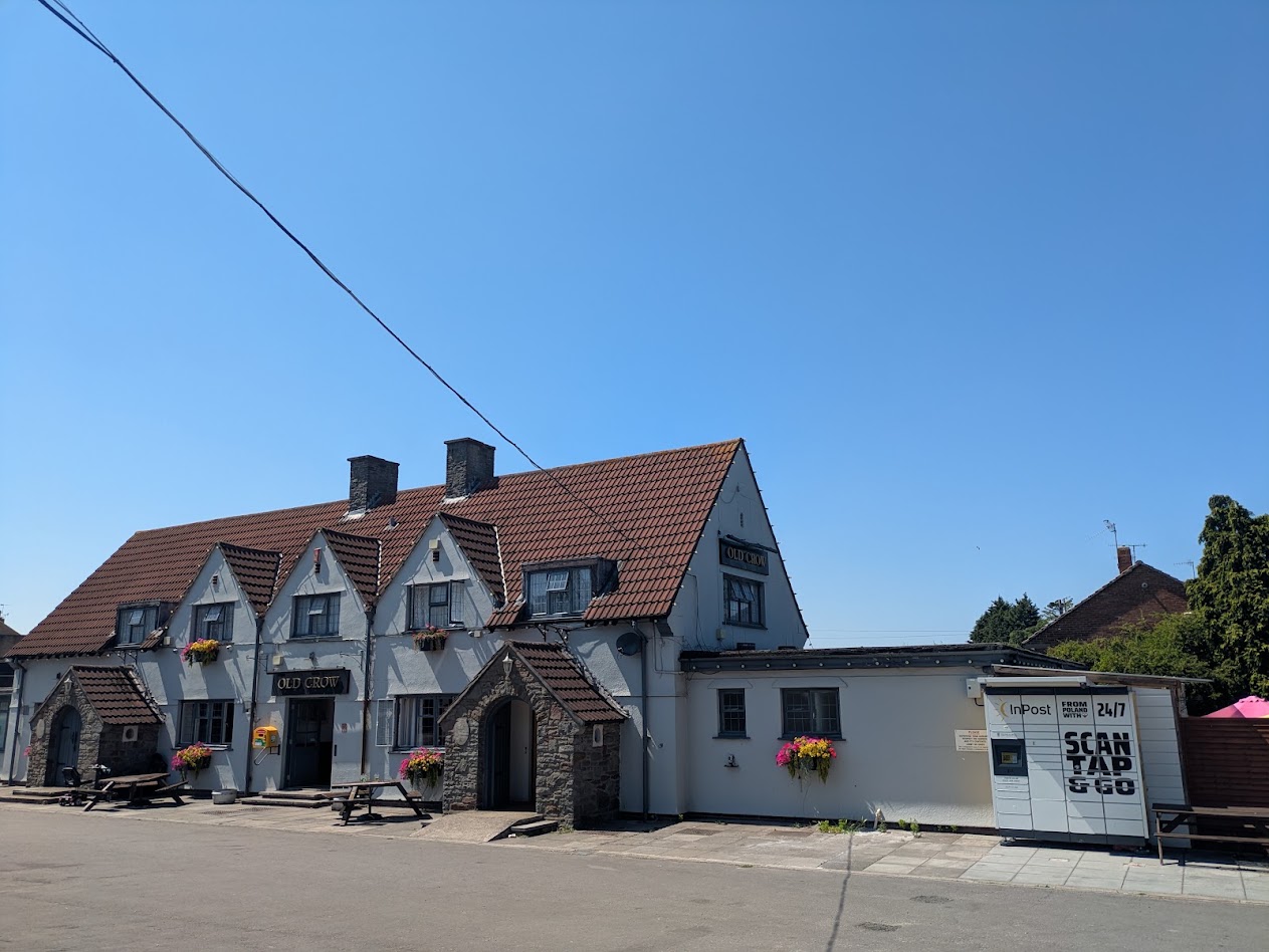 A picture of the outside, a large pub under a bright blue sky