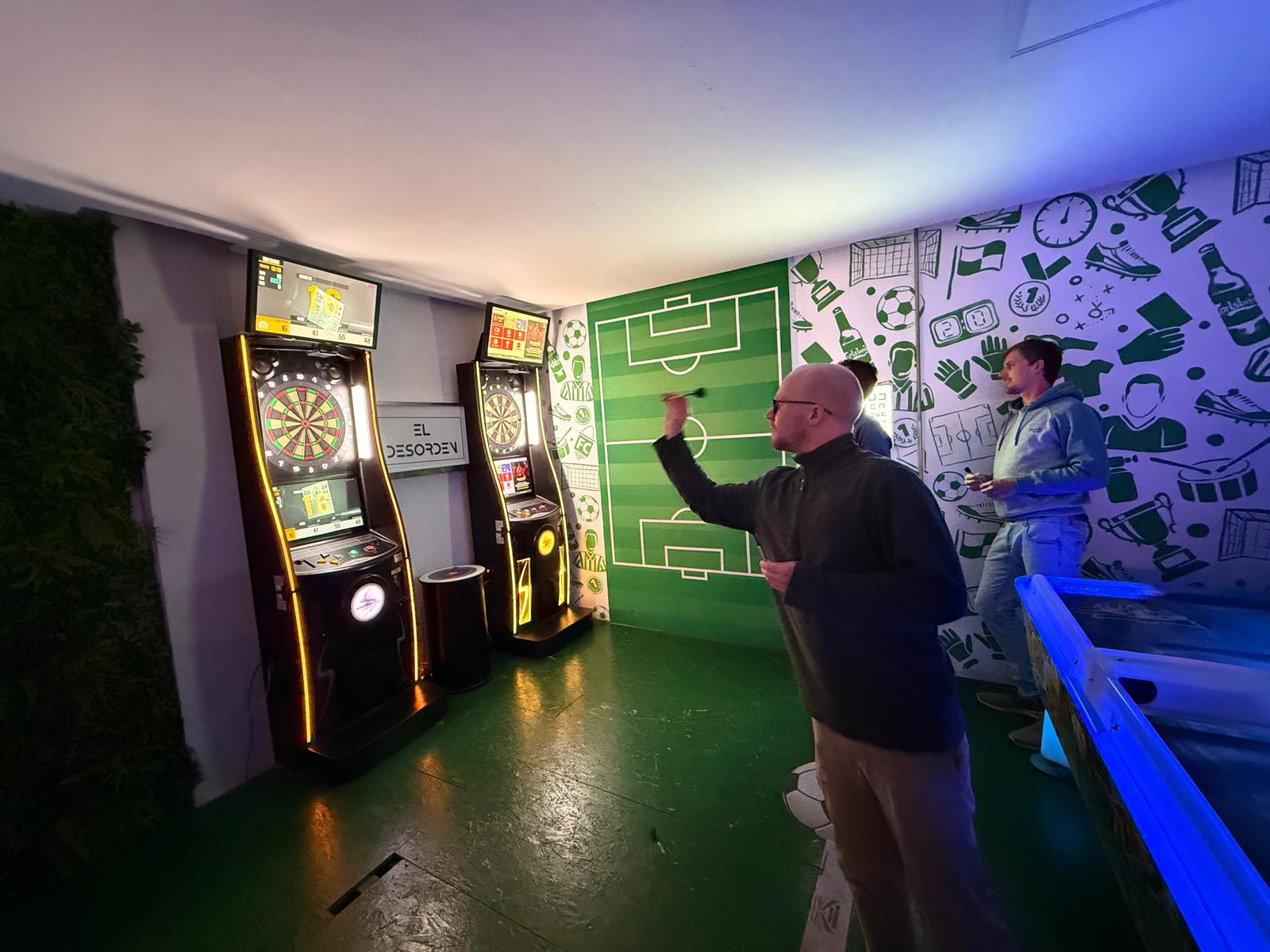 An action shot of me throwing a dart at the soft-tip dart arcade machine