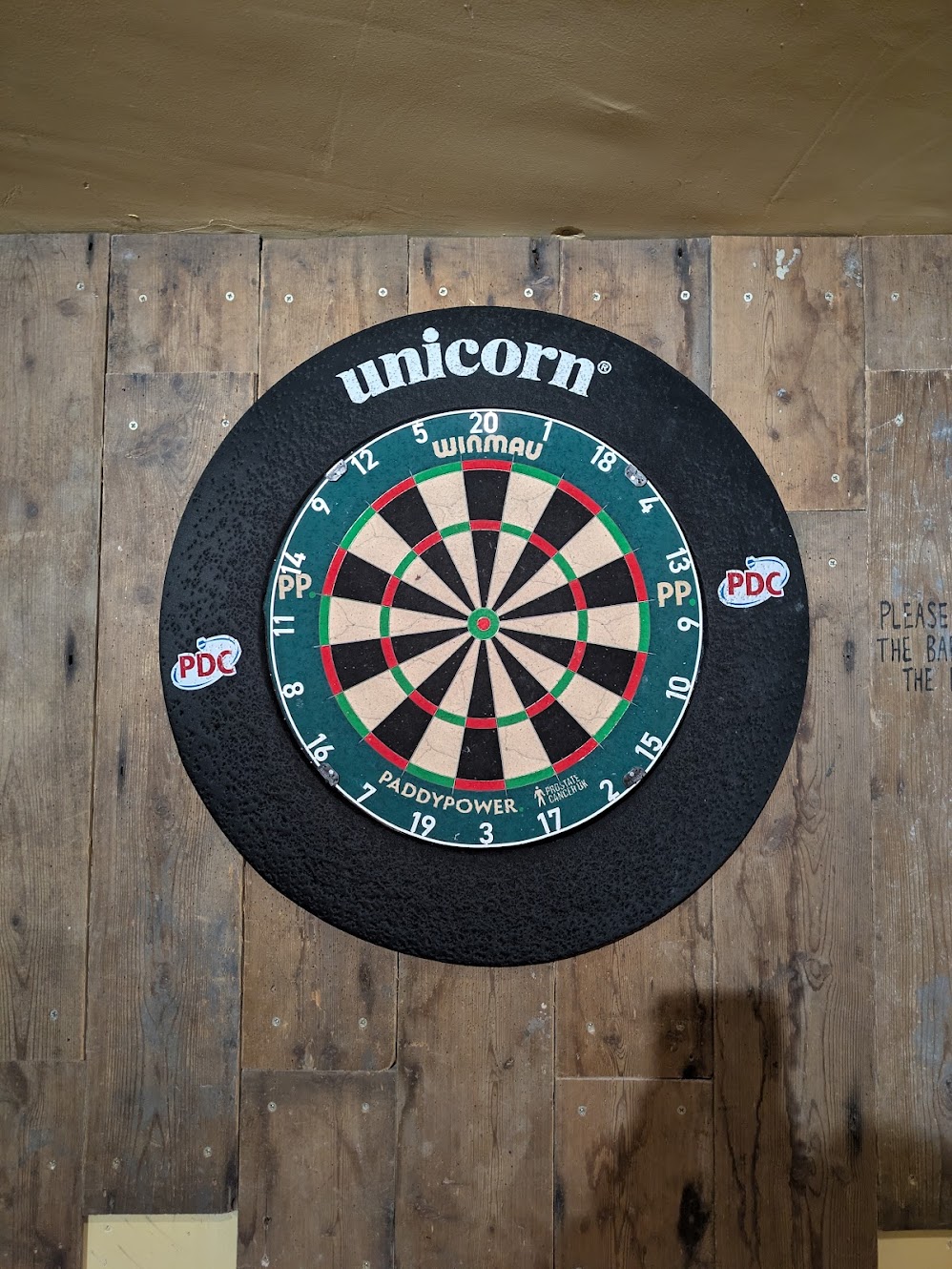 The second dartboard in Industry, with a green surround and Paddy Power logos.