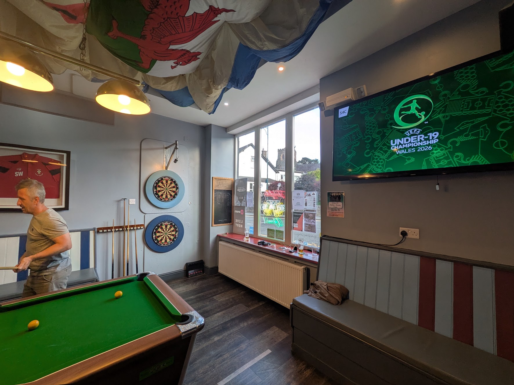 A wider shot of the bar, showing the interesting light mount and pool table