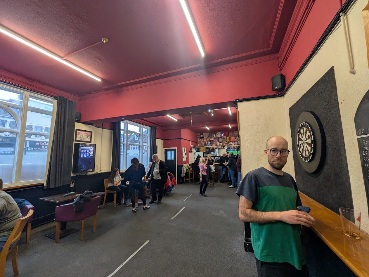 A broader view of the room, showing the entrance, and my mate andrew grimacing a bit