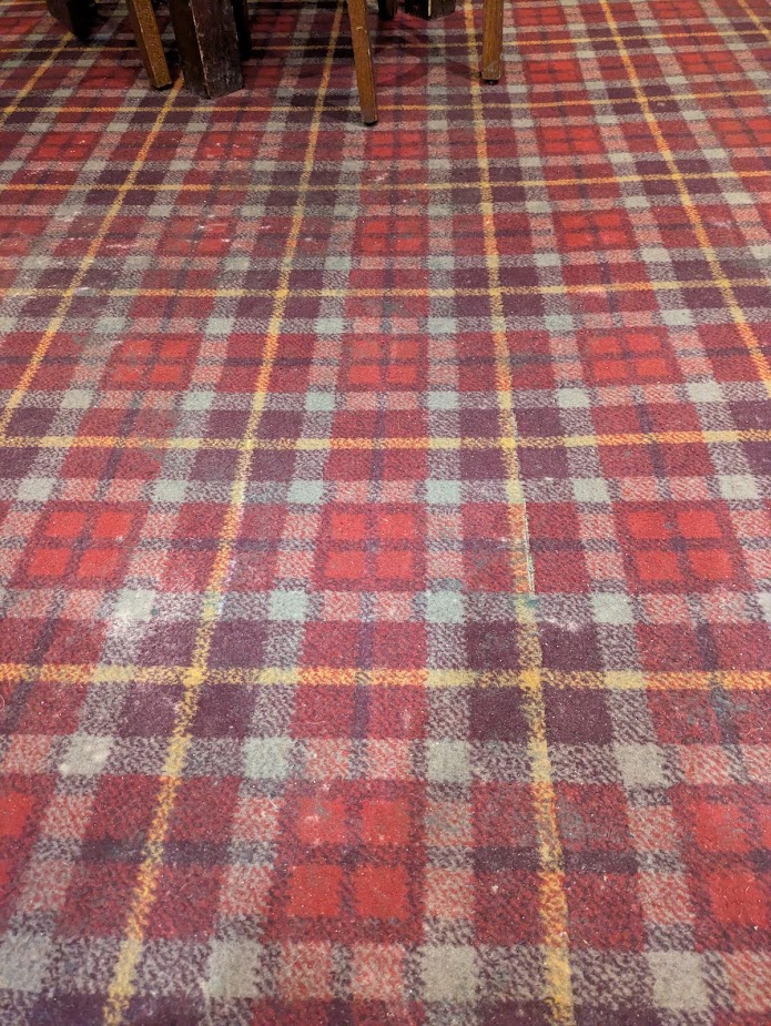 An image of carpet, showing a line cut where the oche was, but not used by us.