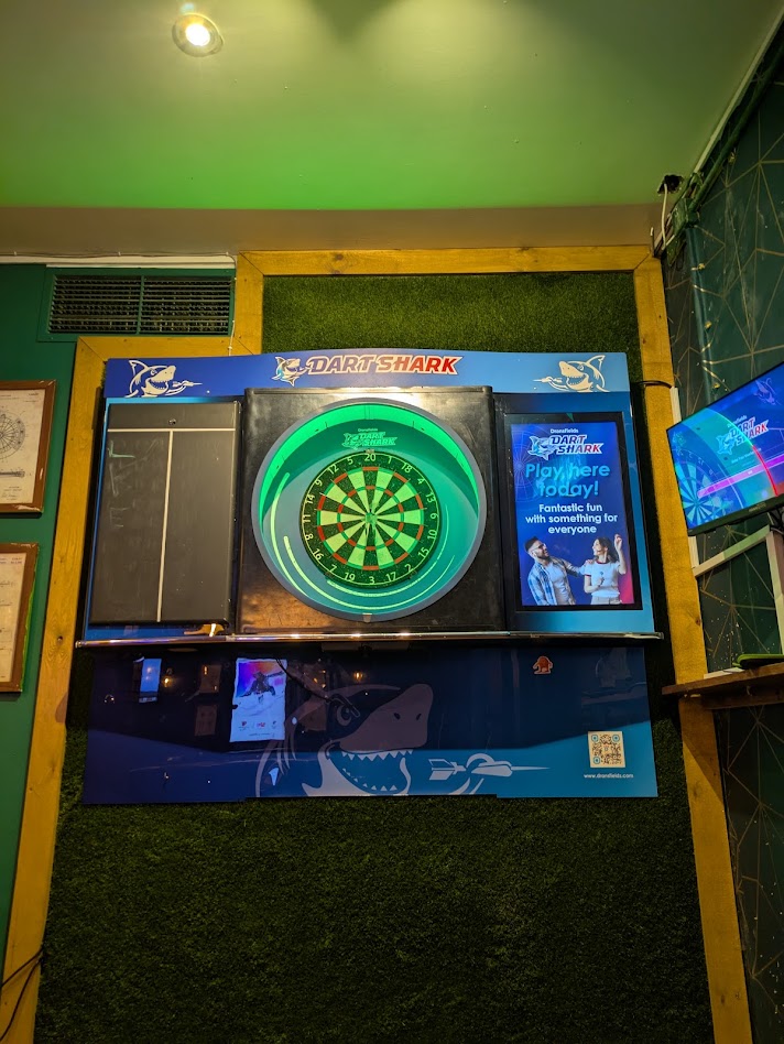 An image from further back showing the dartboard and the case its in