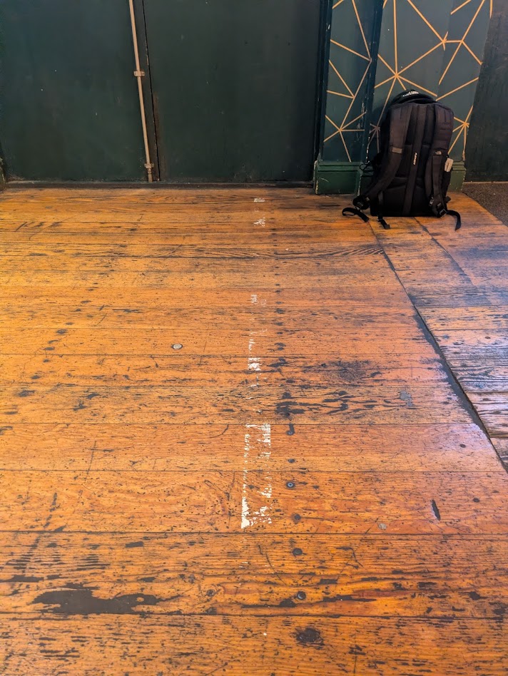 The line of the oche, a painted line about 10x150cm, but very faded